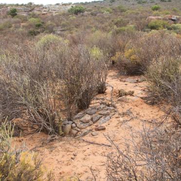 ? Unmarked grave with stones
